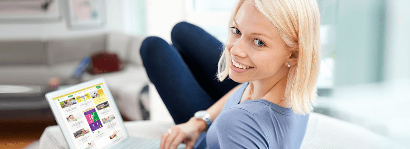 woman with blonde hair lounging on a couch browsing Culturelle's website