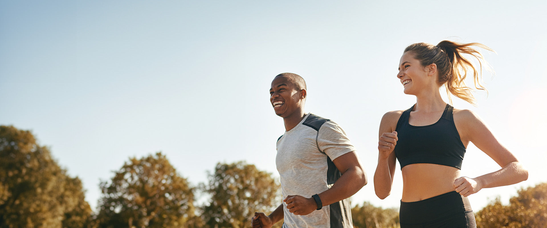 man and woman smiling while running together