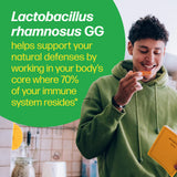 Person eating a supplement with text about Lactobacillus rhamnosus GG in a kitchen setting