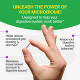 Hand holding a small white device with text about microbiome benefits on a green and white background