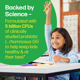 Child raising hand in a classroom with educational text about probiotics on a green background