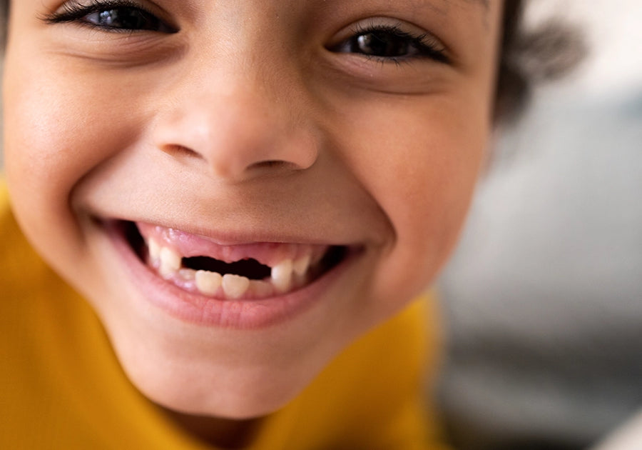 young boy with a toothless smile